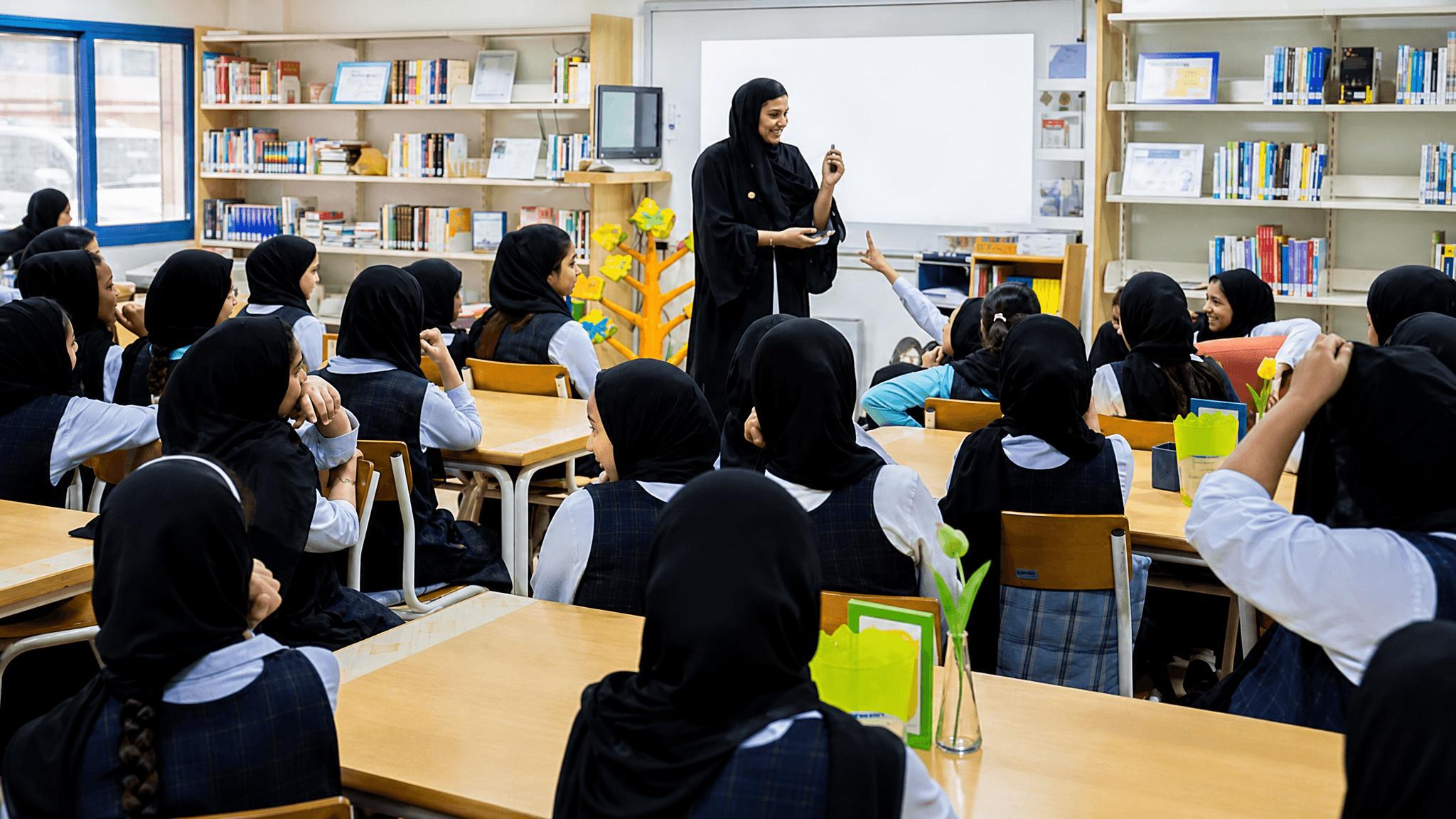 How do families and communities join in Emirati Women's Day?